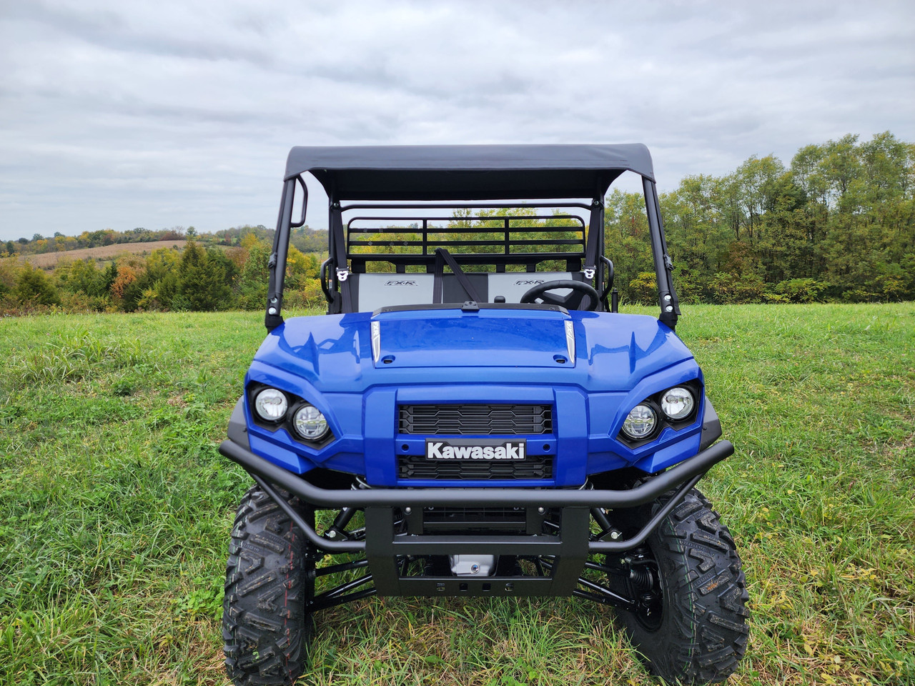 3 Star black canvas top on a blue Kawasaki Pro FXR, head-on view parked in a grassy field