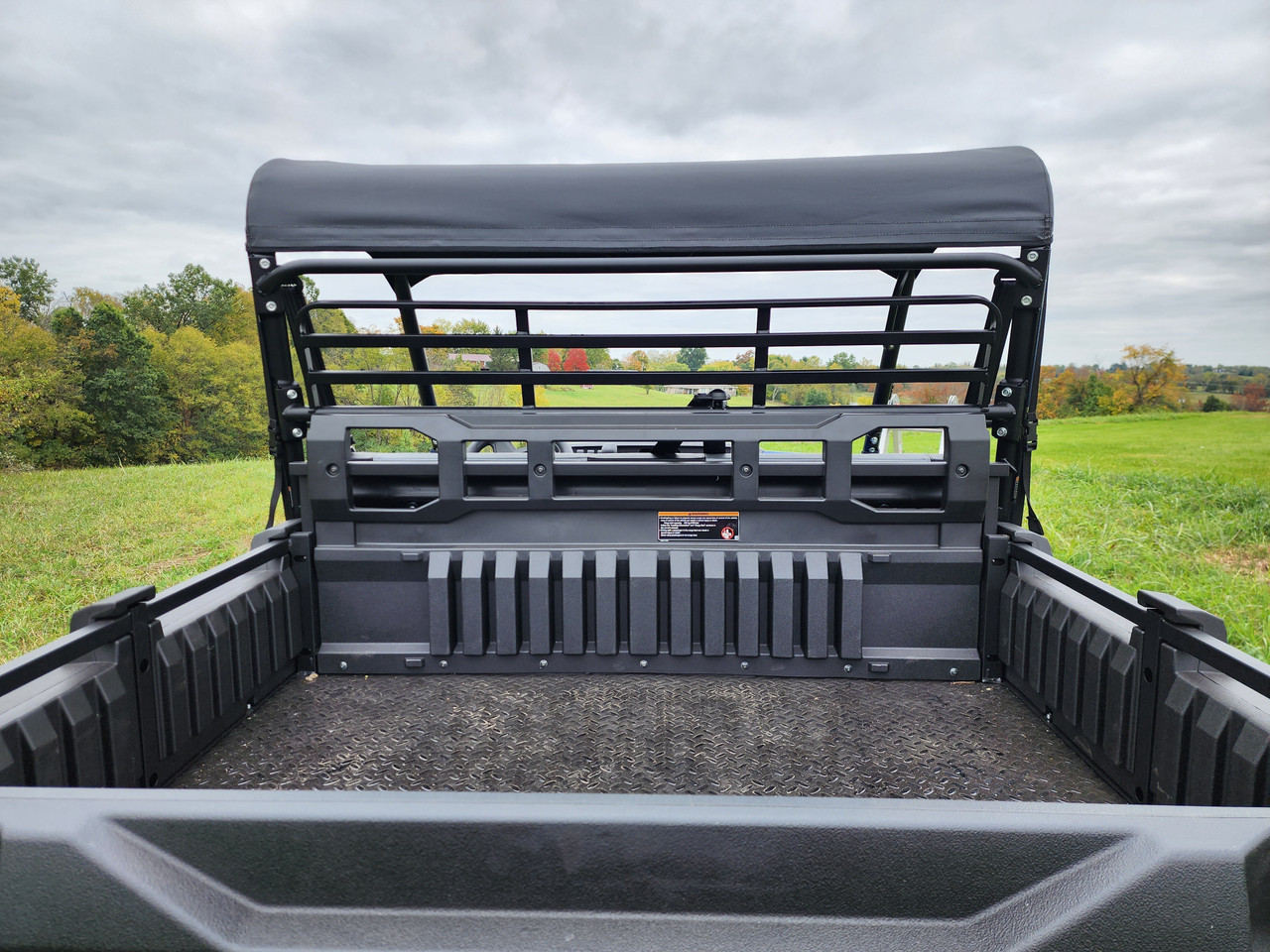 View from the cargo bed of the 3 Star canvas top over the cage and headache rack of a Kawasaki Pro FXR