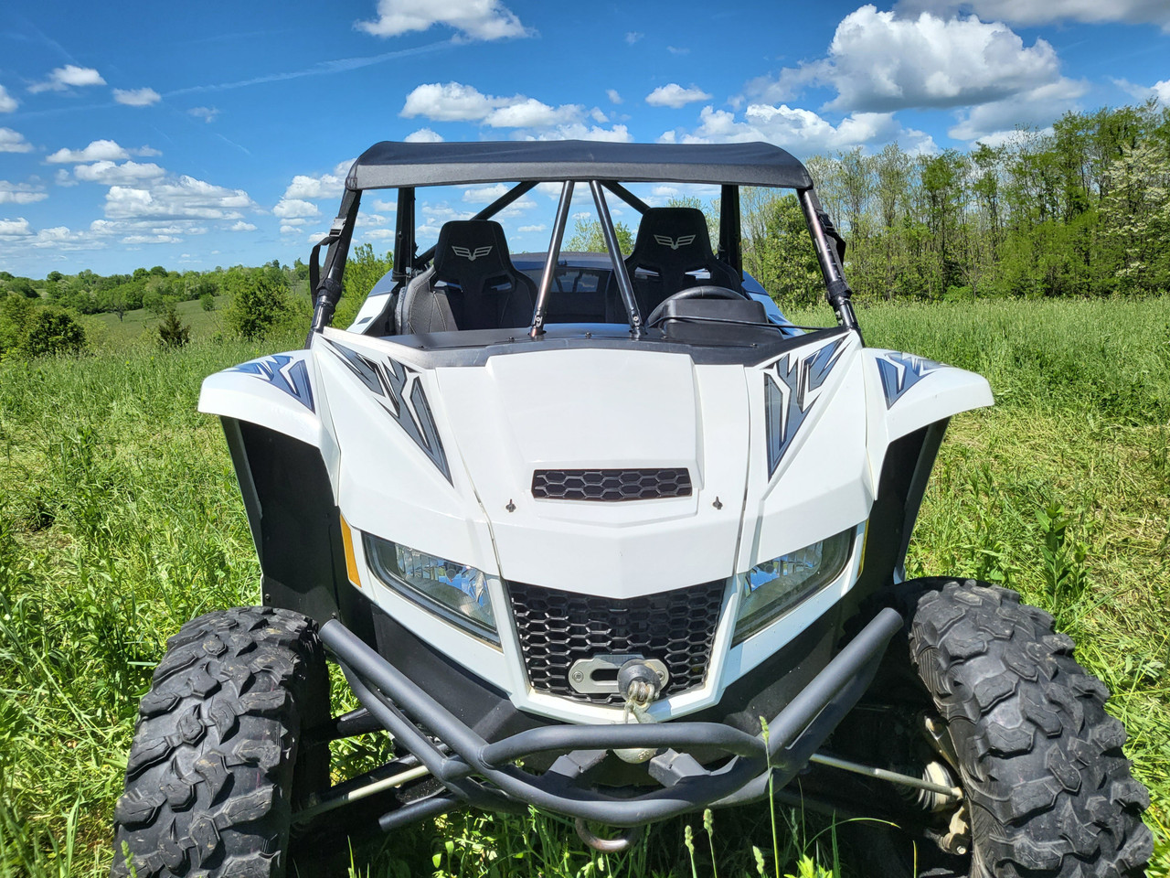 3 Star soft top for a hard windshield on a white Arctic Cat Wildcat XX, straight front view in a field