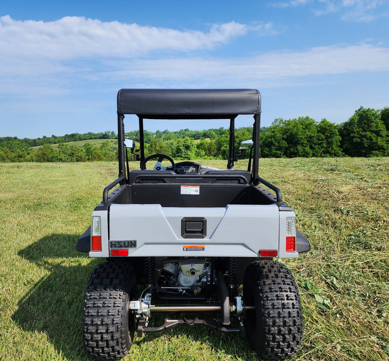 Rear view of a white HiSun Sector 250 with the 3 Star soft top over the open cab and cargo bed
