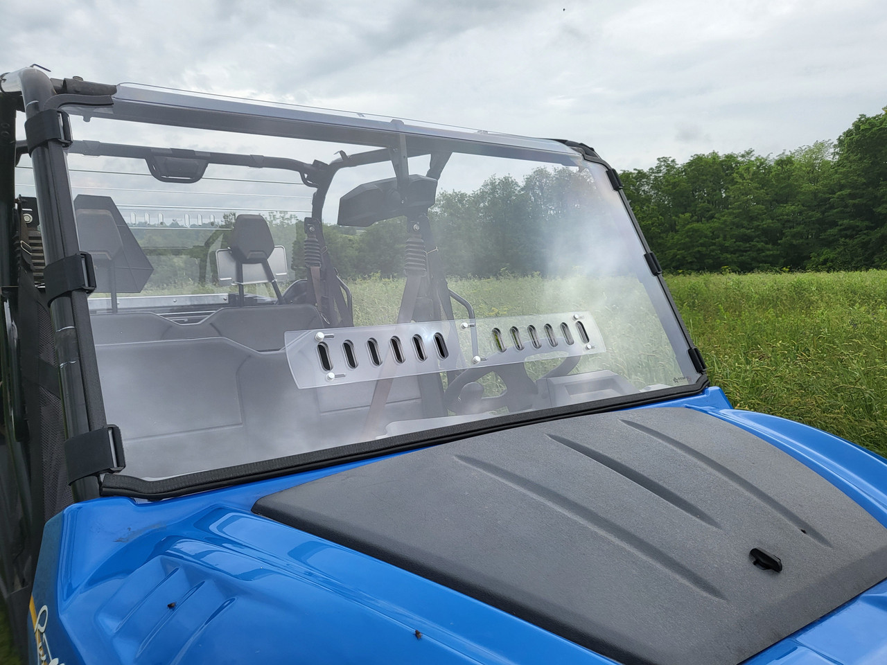 3 Star one-piece general-purpose windshield with vent strip on a blue New Holland 850 Crew, front angle