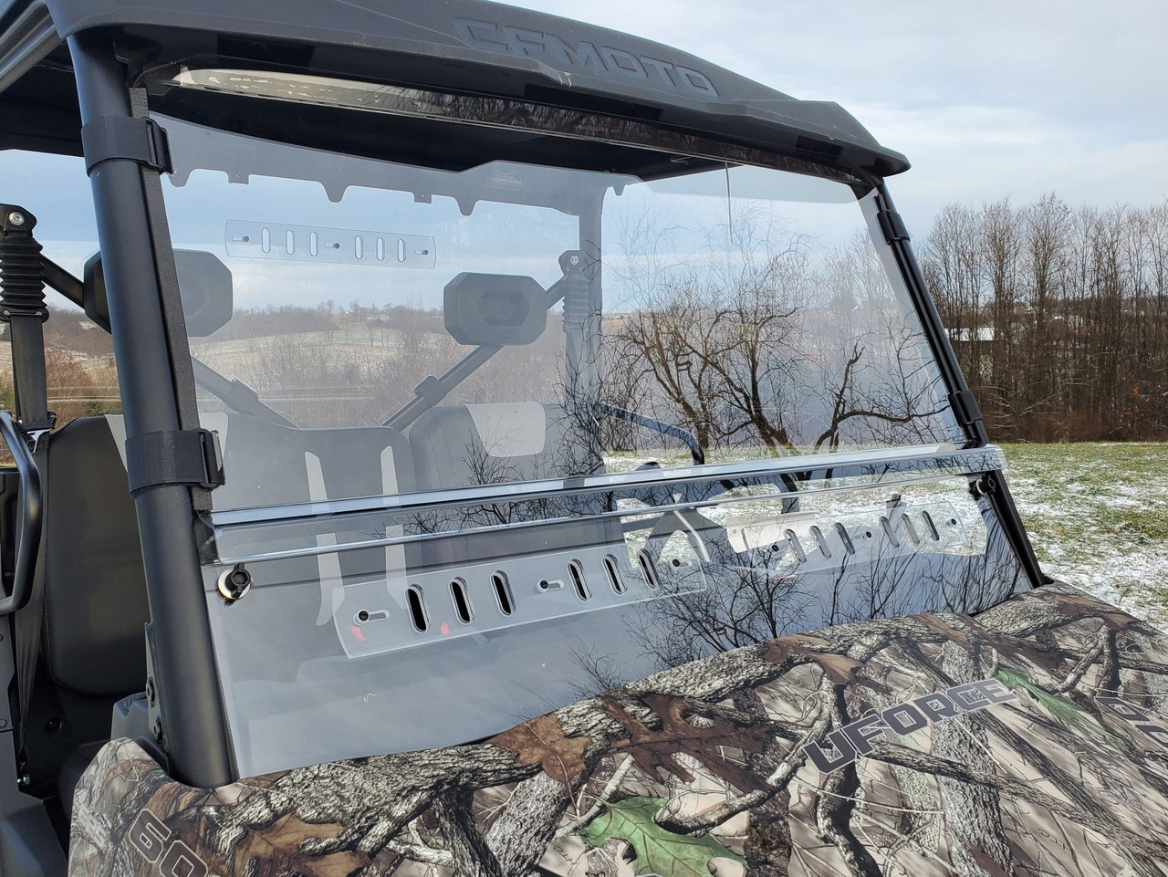 3 Star two-piece windshield with vent slots on a camo CFMoto UForce 600, front view over the hood in winter