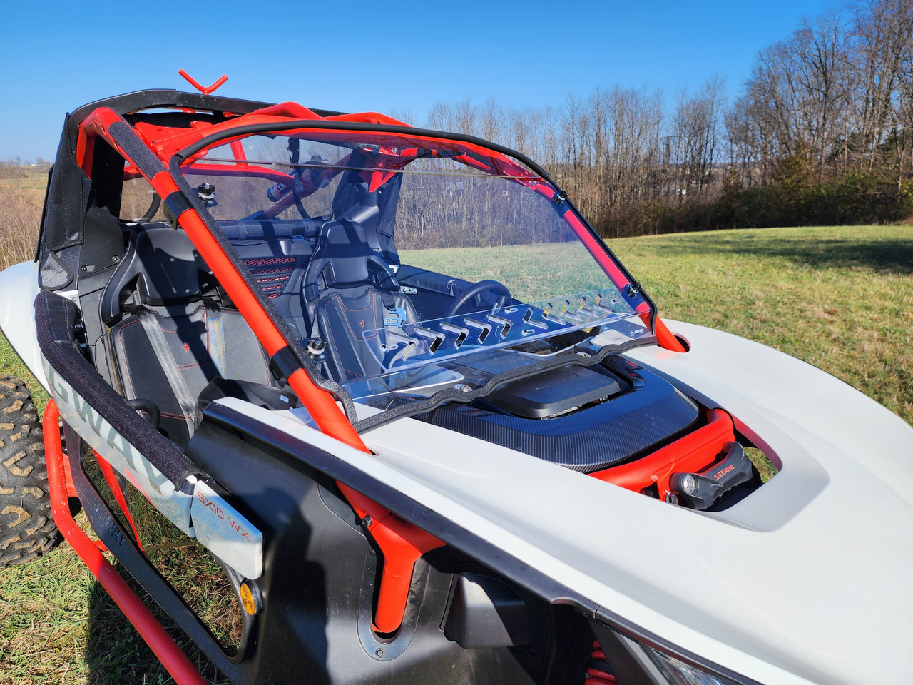 White Segway Villain with the 3 Star 1-piece windshield fitted, driver side front three-quarter view in a field