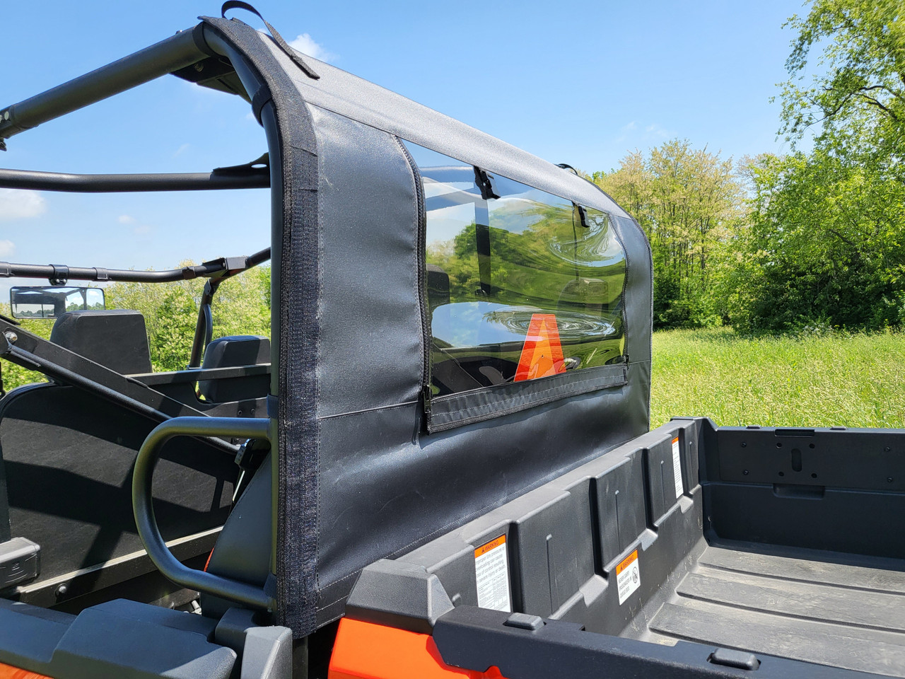 Close-up of the 3 Star soft back panel with clear vinyl window on an orange Intimidator GC1K from the bed side