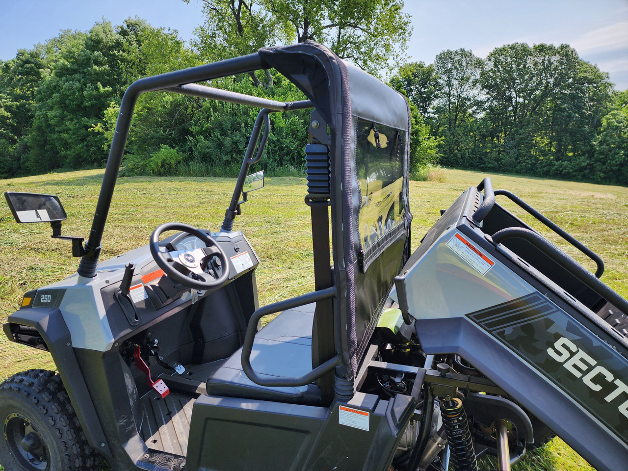 Driver side view of the HiSun Sector 250 with the 3 Star soft back panel installed, bed tilted up and Sector decal visible