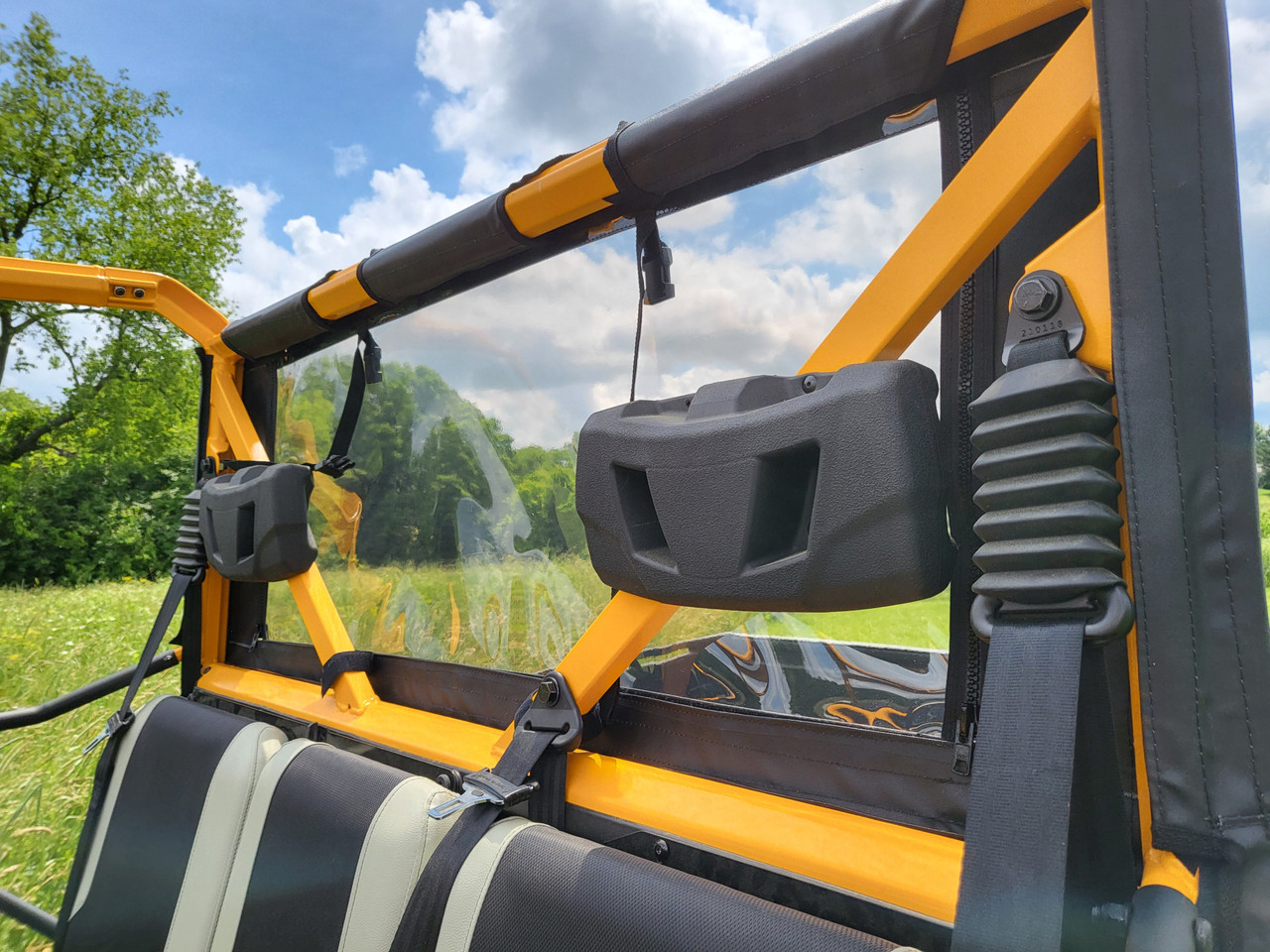 Inside view of the 3 Star soft back panel clear window behind the rear seats of a crew side-by-side with a yellow cage
