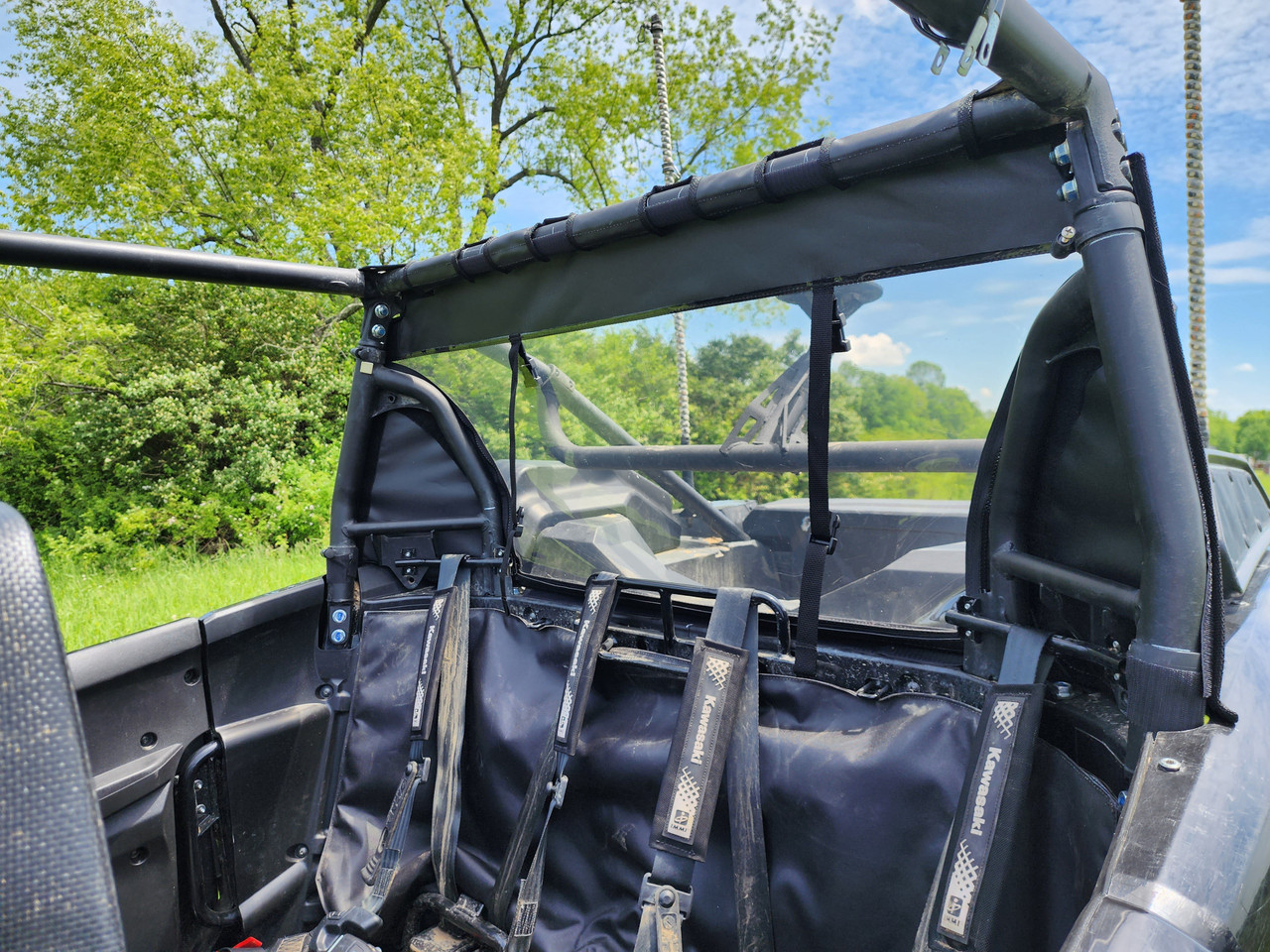 Inside view of the 3 Star canvas rear panel behind the rear seats and harnesses of a Kawasaki Teryx KRX Crew
