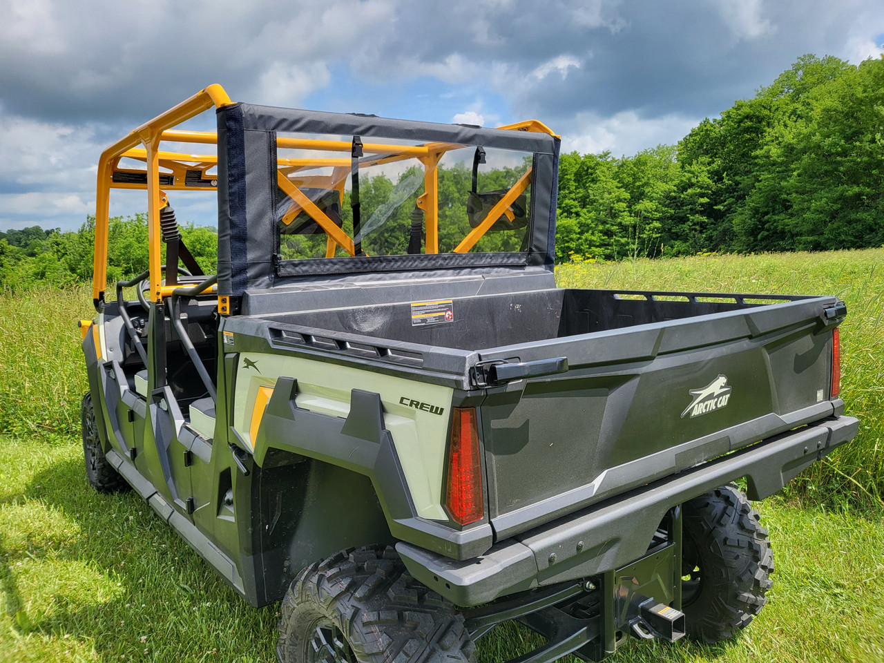 Rear three-quarter view of the Arctic Cat Prowler Pro Crew with the 3 Star soft back panel in a field