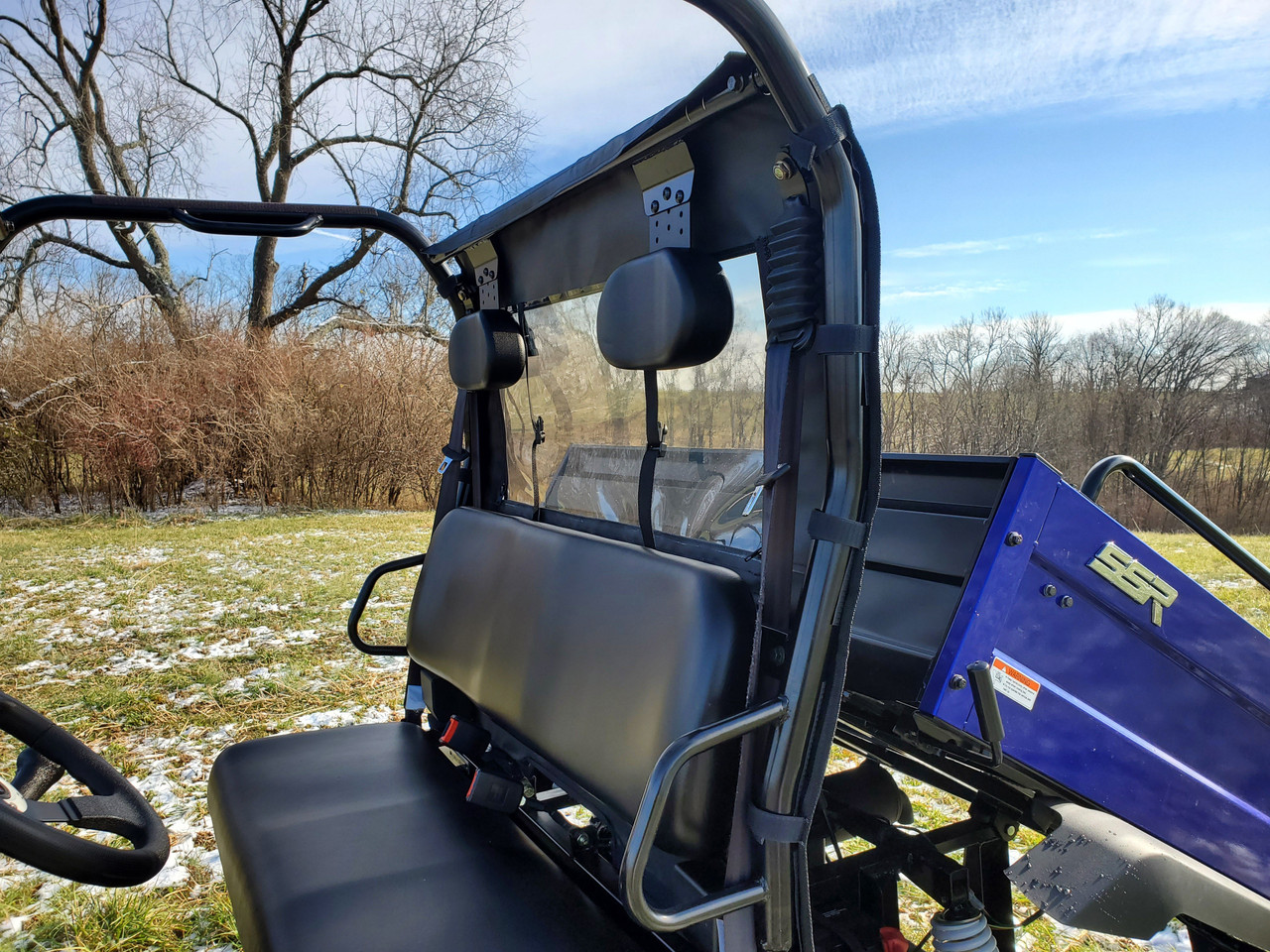 Inside view of the 3 Star soft back panel and window behind the bench seat of a blue Bison 400U