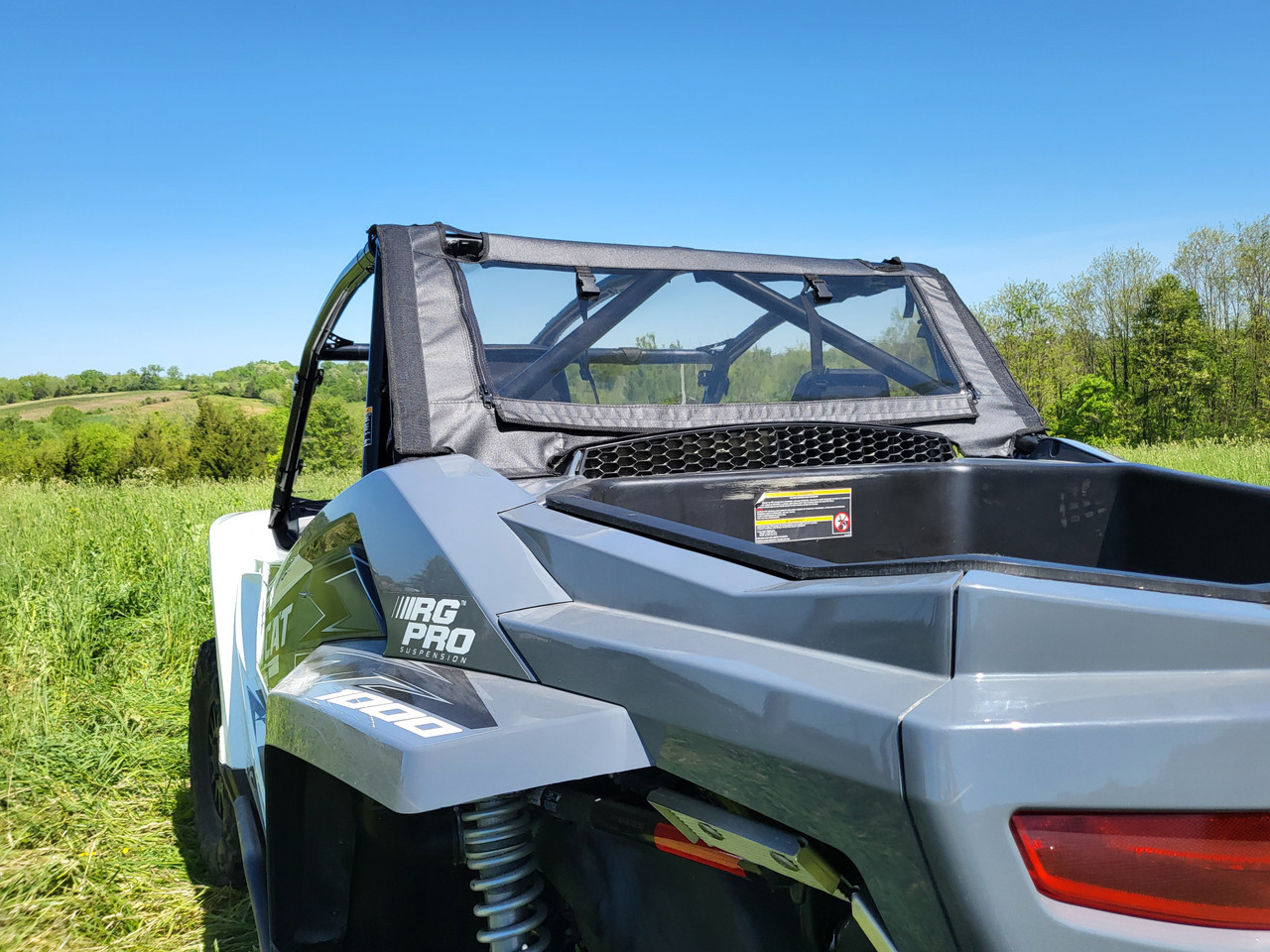 Straight rear view of the 3 Star back panel mesh window above the cargo area of a gray Arctic Cat Wildcat XX