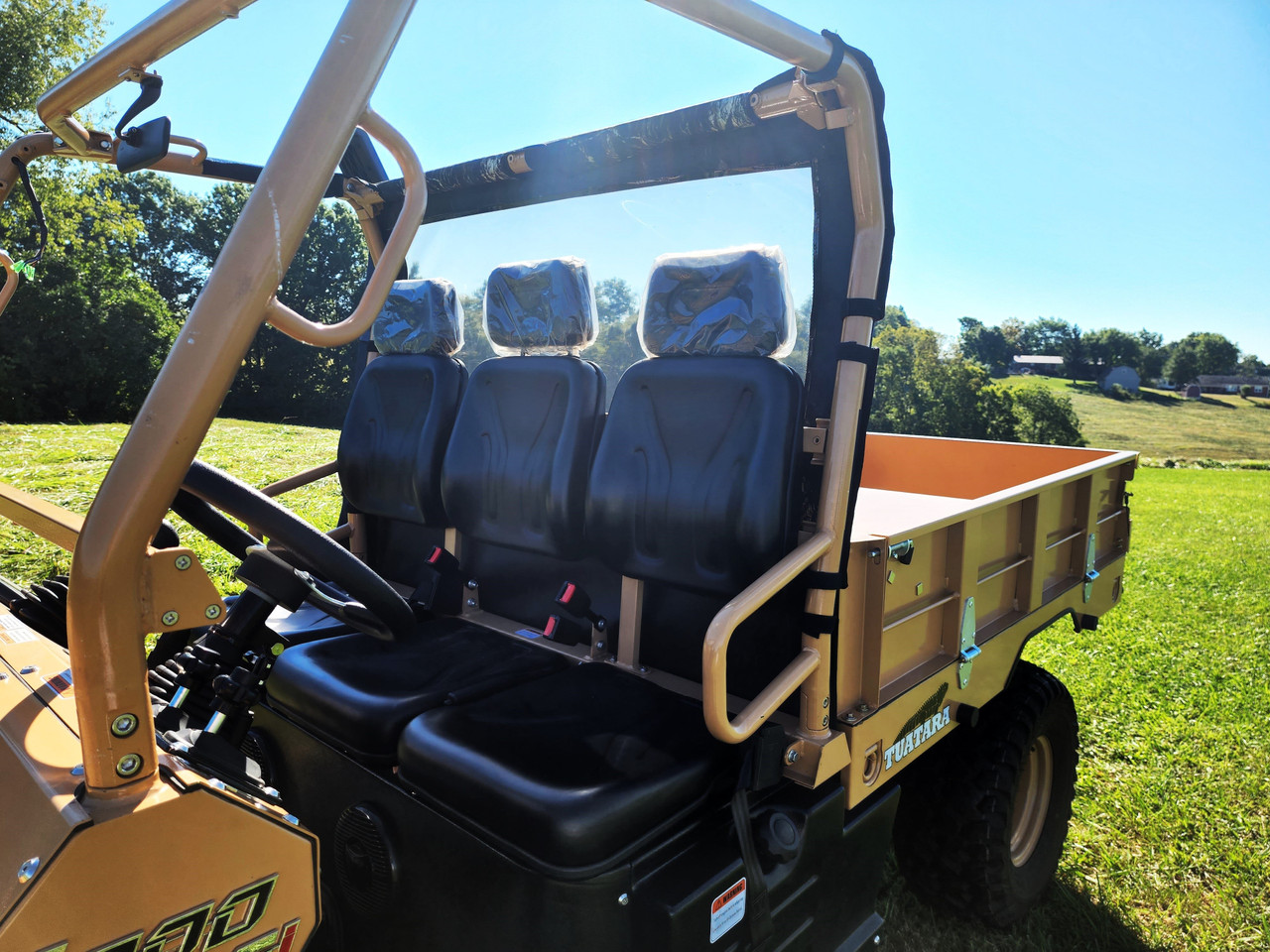 Inside view of the 3 Star soft back panel behind the three bench seats of a tan Tuatara, clear window and cage