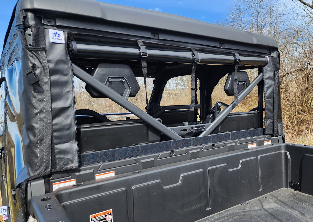 Angled view of the 3 Star soft back panel on the CFMoto UForce 1000XL from the cargo bed, trees behind