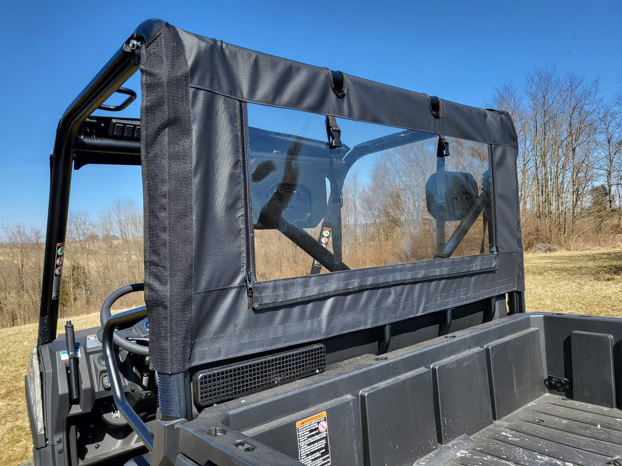 Driver side view of the 3 Star soft back panel strapped to the CFMoto UForce 600 cage over the bed