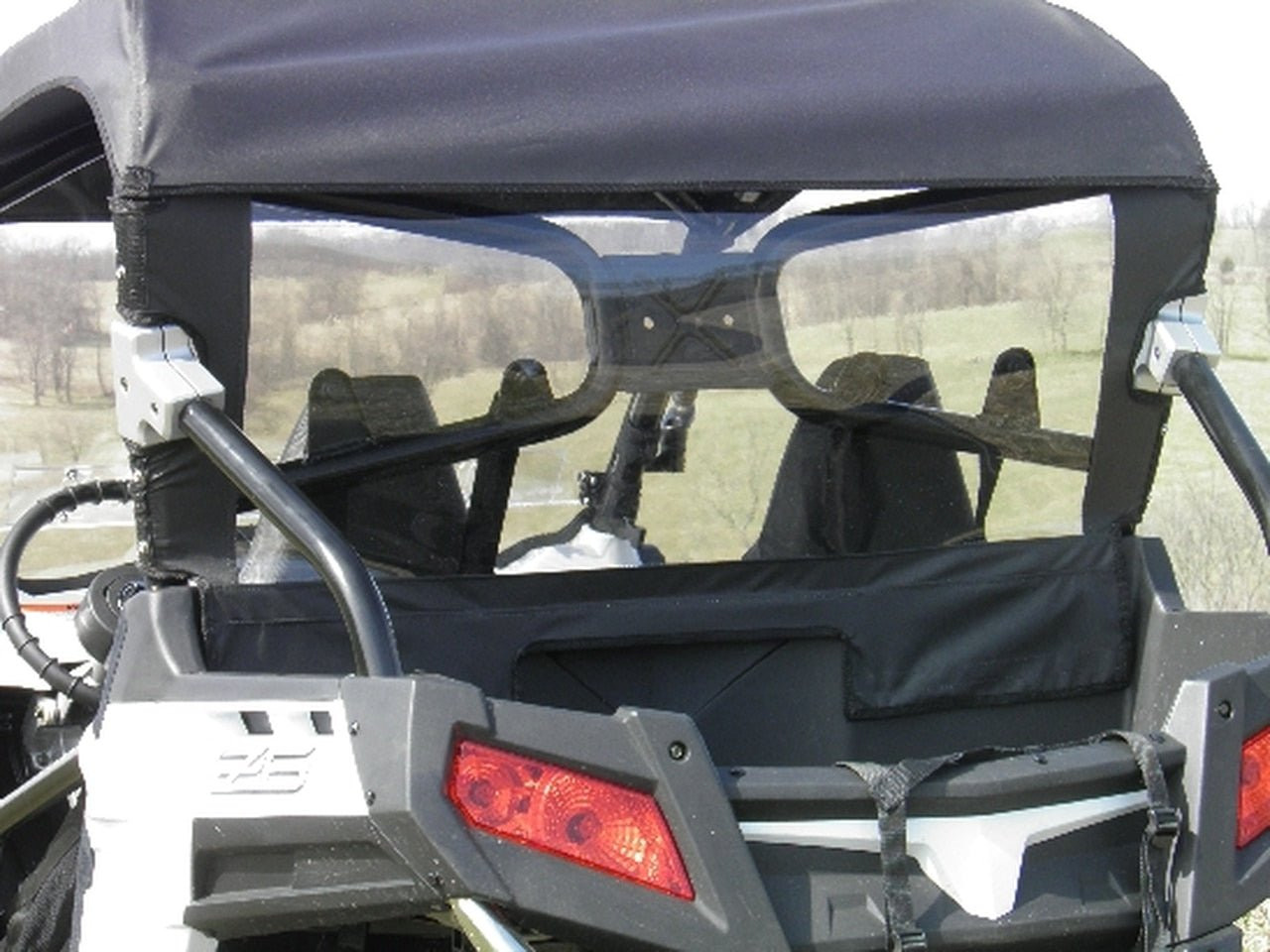 Close-up of the 3 Star soft back panel with clear window behind the seats of a white CFMoto ZForce 600