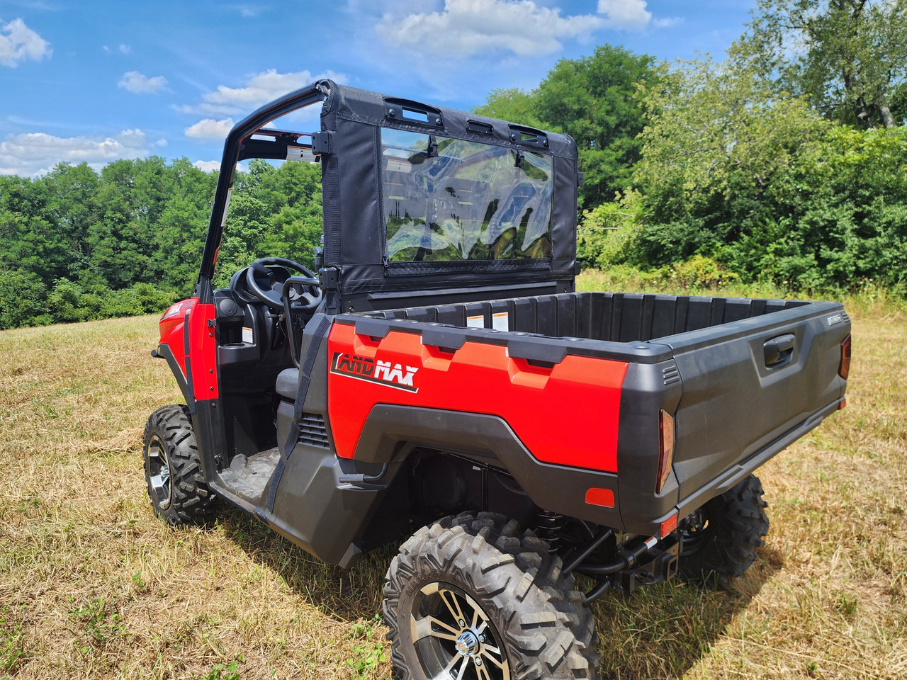 Rear three-quarter view of a red ARGO Magnum XF 1000 LE with the 3 Star soft back panel and top in a field