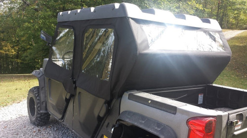 Rear three-quarter view of the Side X Side cab enclosure on the gray Bennche X4 showing the rear window and bed
