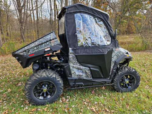 Side X Side full cab enclosure on a camo Massimo T-Boss with the cargo bed tilted up, driver side view in a field