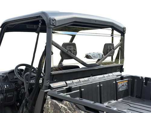 Spike rear windshield for Can-Am Defender and Defender MAX: tinted rear windshield on a camo UTV, view over the bed