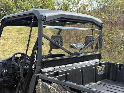 Spike rear windshield for Can-Am Defender and Defender MAX: rear windshield on a camo UTV, view over the bed