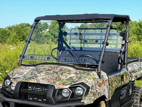 Spike windshield for Kawasaki Mule Pro-MX: vented windshield on a camo UTV, front view in a field