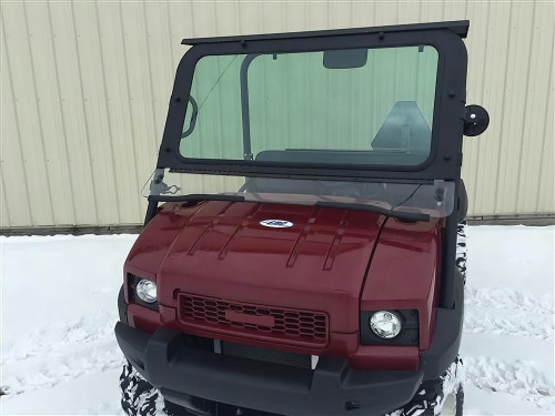 Extreme Metal Products glass windshield installed on a maroon Kawasaki Mule 4010 in snow, front view