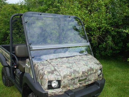 Extreme Metal Products full windshield installed on a camo Kawasaki Mule 4010, front three-quarter view on grass