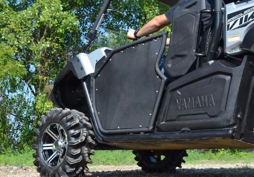 SuperATV aluminum half door on a Yamaha Viking, passenger side rear angle showing the door and mud tire