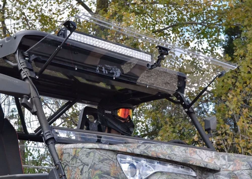 SuperATV flip-up windshield on the Odes Dominator raised to the open position under the roof and light bar