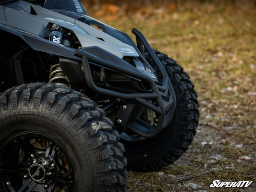 Low side angle of the SuperATV front bumper wrapping the front corner of the Yamaha YXZ beside the front tire