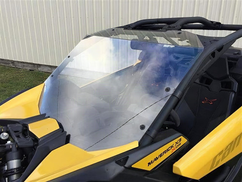 Extreme Metal Products windshield on a yellow Can Am Maverick X3, front three-quarter view reflecting the sky