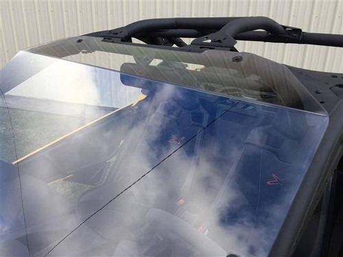 Straight-on close-up of the clear Extreme Metal Products windshield surface on the yellow Can Am Maverick X3