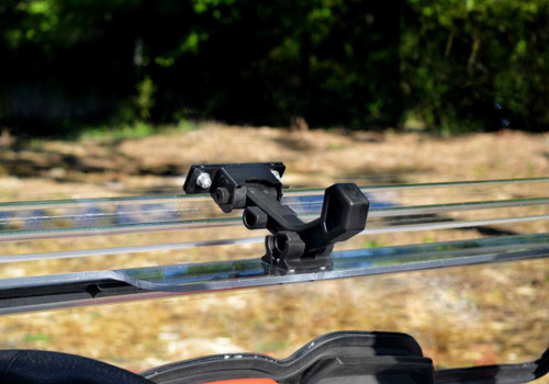 Close-up of the SuperATV windshield latch handle on the lower windshield section of the Kymco UXV 450 from inside the cab