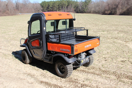 Seizmik universal rear dump bed rack mounted on an orange utility side-by-side, rear three-quarter view