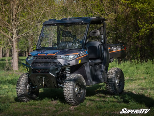 SuperATV scratch resistant flip windshield on a Polaris Ranger XP 1000, front three-quarter view in the woods