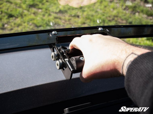 Hand working the SuperATV flip windshield latch on the Polaris Ranger XP 1000 dash