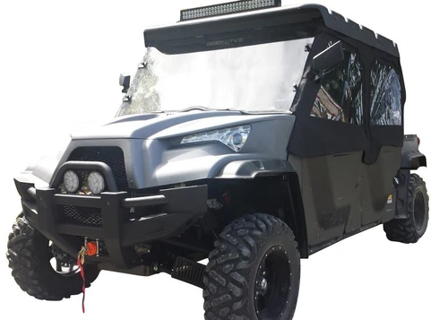 Side X Side full cab enclosure with clear windows installed on a gray Odes Dominator X4, front three-quarter view