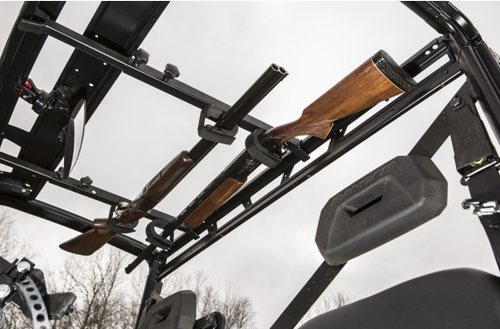 Kolpin overhead in-cab gun rack holding two rifles under a side-by-side roof, view looking up