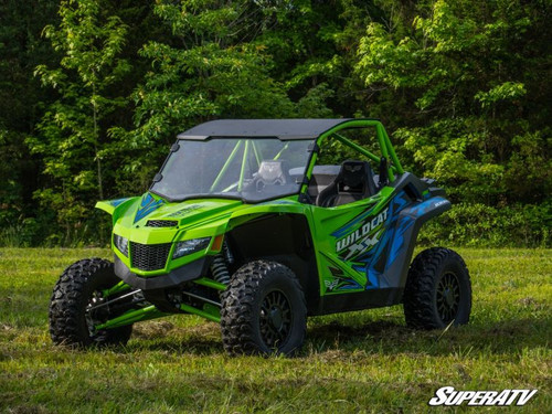 SuperATV full scratch resistant windshield on a green Textron Wildcat XX, front three-quarter view in a field