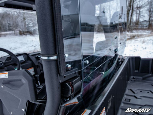 SuperATV clear rear windshield edge and cage clamp on a red Yamaha Wolverine X2 in snow, close side view