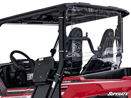 Driver side view of the red Yamaha Wolverine X2 cab with the SuperATV rear windshield behind the seats under the roof