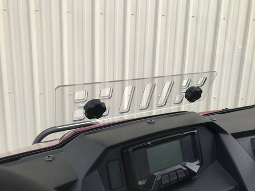 Inside view of the Extreme Metal Products windshield vent panel with two black knobs above the Wolverine X2 dash