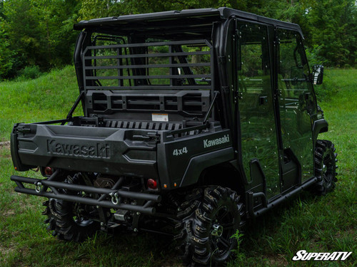 Rear three-quarter view of the black Kawasaki Mule FXT with SuperATV cab enclosure doors, tailgate and rear bumper