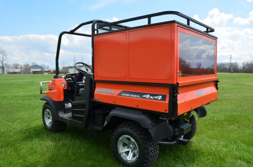 Wiedmann Bros Challenger 24-inch glass-door bed cap on a Kubota RTV 900/1100, rear three-quarter view
