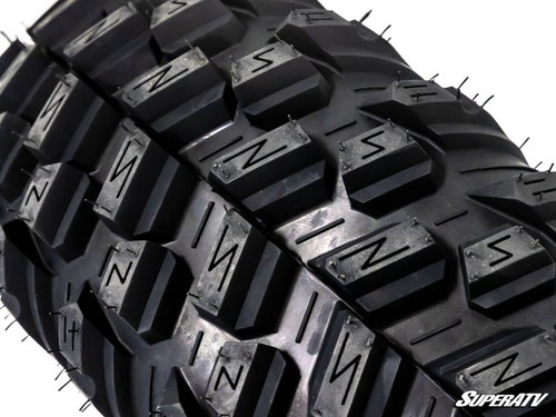 Close-up of the aggressive tread pattern on a SuperATV XT Warrior SlikRok Edition tire
