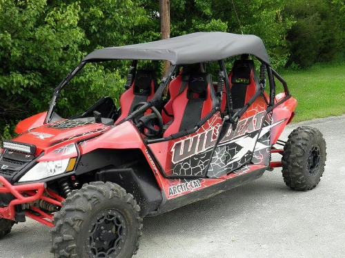 3 Star black soft top installed on a red Arctic Cat Wildcat 4, front three-quarter view on pavement