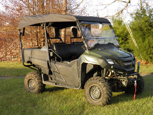 3 Star black soft top installed on a green Honda Pioneer 700-4, front three-quarter view in a field