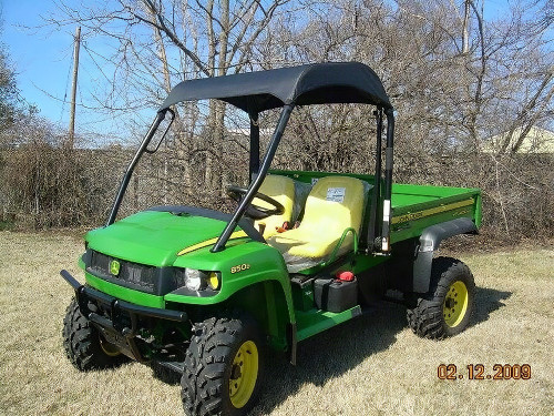 3 Star black soft top installed on a green John Deere Gator HPX/XUV, front three-quarter view in a grass field