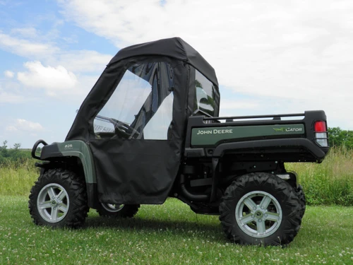 Passenger side view of the 3 Star soft doors with clear windows on a green John Deere Gator XUV in a field