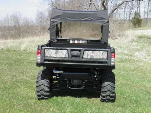 Rear view of a camo John Deere Gator XUV-4 with 3 Star soft back panel and soft top in a field
