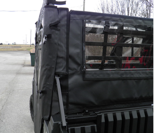 3 Star black soft back panel with window strapped behind the cab of a Kawasaki Mule Pro-FXT, seen from the bed